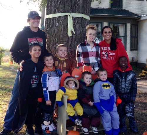 Luke Buttry's family at Halloween. Parents Luke and Kathy stand on the ends, with daughter Hailie standing about as tall as her mother. Trenton, adopted from Haiti, is standing by Kathy. Sitting, left to right, are Grayson, Kyler and Landry. Standing in front of Luke, from left, are Andreas, Brody and Carter. 
